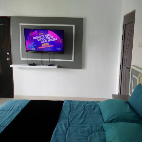 a living room with a tv and a couch at Captain's Cabin Resort - Naval Heritage (Swimming Pool) in Kota Bharu
