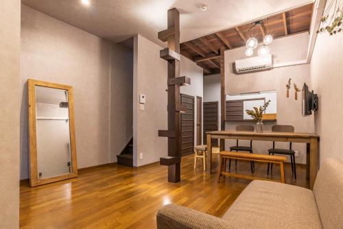 a living room with a dining room table and a loft bed at ビジュースイーツ Century in Osaka