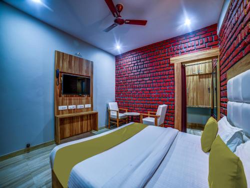 a bedroom with a bed and a tv in it at Sahastradhara RiverResort in Dehradun