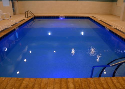 a large swimming pool with blue water at Holiday Inn Express & Suites - Pittsburgh - Monroeville by IHG in Monroeville