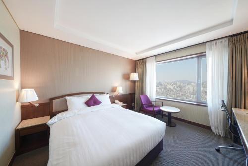 a hotel room with a bed and a large window at Best Western Premier Gangnam Hotel in Seoul