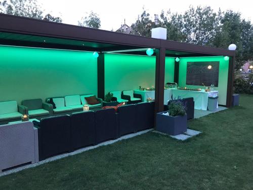 an outdoor dining area with green lighting at Hotel Tarvisio Four Seasons in Tarvisio