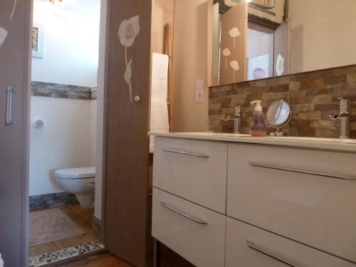 a bathroom with a sink and a toilet at Domaine Le Village in Villenouvelle