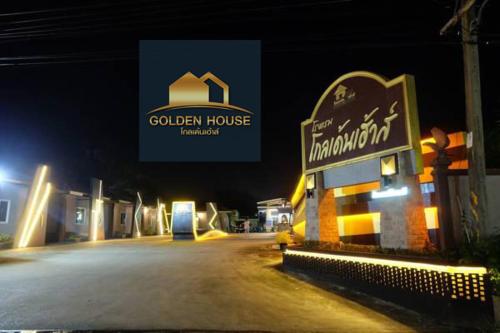 a sign for a golden house on a street at night at Golden House Hotel Sakaeo in Sa Kaeo