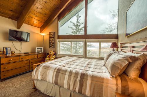 a bedroom with a large bed and a large window at Bear Paradise in Lake Arrowhead