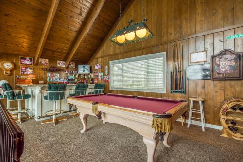 a pool table in a room with wooden walls at Bear Paradise in Lake Arrowhead