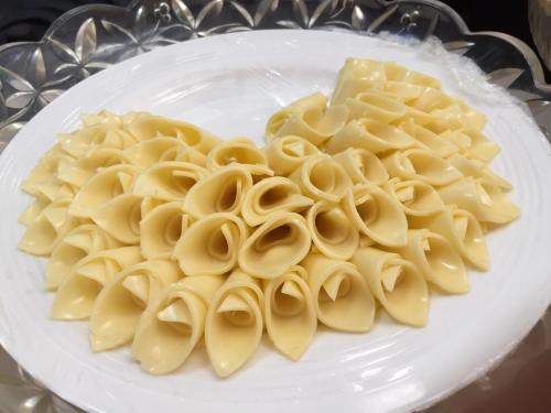 a plate of pasta and cheese on a table at Chaweng Noi Pool Villa in Chaweng Noi Beach