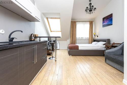 a kitchen with a sink and a bedroom with a bed at Old Tallinn Apartments in Tallinn