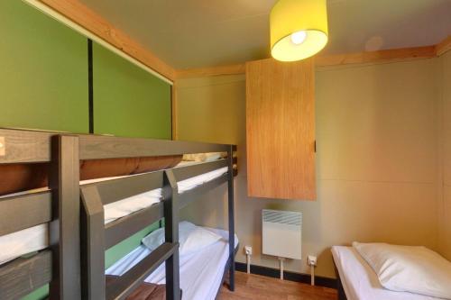 a room with two bunk beds and a light at Camping le Petit Liou Sites & Paysages in Baratier