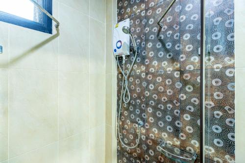 a shower with a shower curtain in a bathroom at The Pool Resort in Bangkok