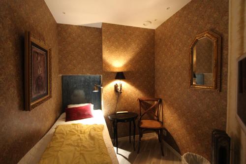 a bedroom with a bed and a chair at Skanstulls Boutique Hostel in Stockholm