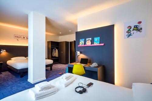 
a hotel room with a toilet and a television at ibis Styles Liege Guillemins in Liège
