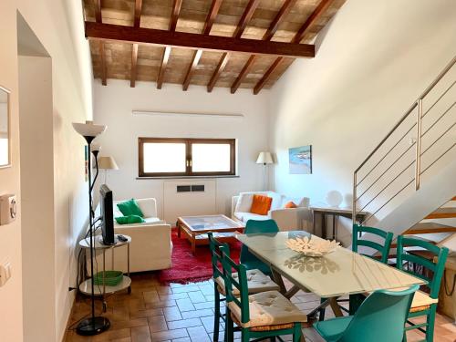 a living room with a table and chairs at Agriturismo Potrero Grande sul Lago di Martignano con spiaggia in Campagnano di Roma