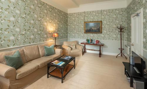 a living room with a couch and a table at The Lauderdale at Thirlestane Castle in Lauder