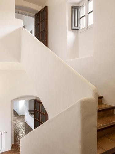 a staircase in a house with white walls at Mas de Torrent Hotel & Spa, Relais & Châteaux in Torrent