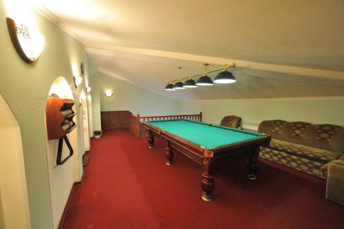 a room with a pool table and chairs at Uspenskaya Hotel in Uglich