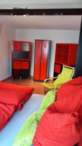 two beds in a room with red and green at Ferienhaus Ainsen in Bad Füssing
