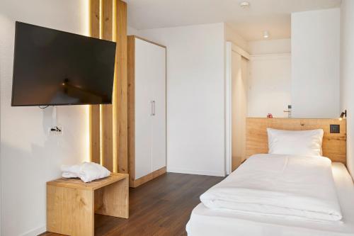Ένα ή περισσότερα κρεβάτια σε δωμάτιο στο Hotel Rössli Gourmet & Spa