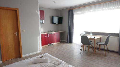 a living room with a bed and a table and chairs at Ostseehotel Kappeln by team SchleiFee in Kappeln