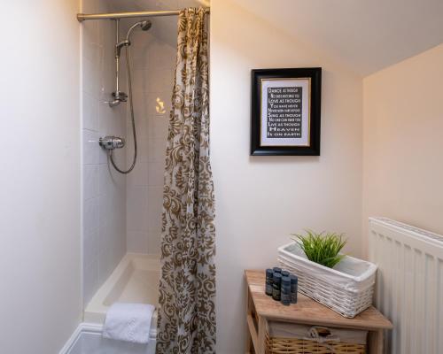 a bathroom with a shower with a shower curtain at Luxury Living, Stylish Modern Apartment in the Heart of Ryde in Ryde