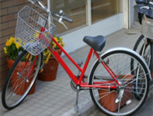 a red bike parked in front of a building at Hotel Grand Terrace Toyama in Toyama