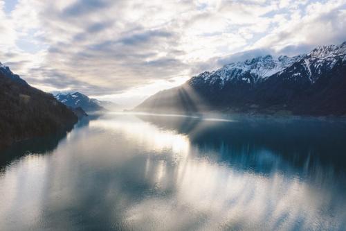 a view of a lake with snow covered mountains at The HEY HOTEL in Interlaken