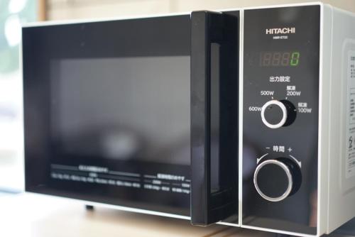 a microwave oven sitting on top of a table at fico HIJI in Hiji