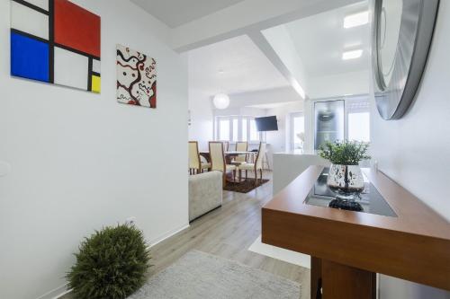 a living room with a table and a dining room at Volcanic Ocean View (Ponta Delgada historic center) in Ponta Delgada