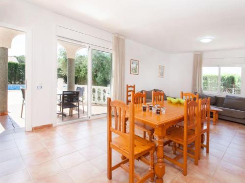 - une salle à manger avec une table et des chaises en bois dans l'établissement Villa Villa Cala Vidre A by Interhome, à Les tres Cales