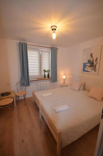 A bed or beds in a room at Blue Sail Sopot Apartments