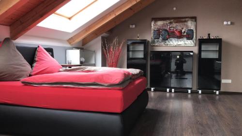 a bedroom with a red bed and a fireplace at Stadtvilla Intzeplatz - Apartment Norderney in Remscheid