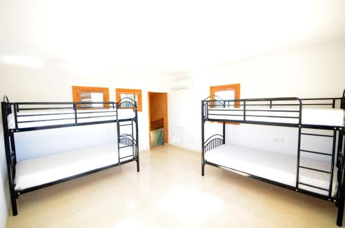 two bunk beds in a room with wooden floors at Villa Dinastía Resort Lujo in Llucmajor
