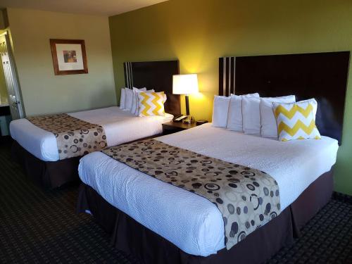 a hotel room with two beds and a lamp at SureStay Hotel by Best Western Vallejo Napa Valley in Vallejo
