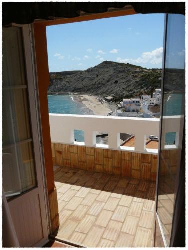 a balcony with a view of a beach and the ocean at Apartamentos Os Descobrimentos in Burgau