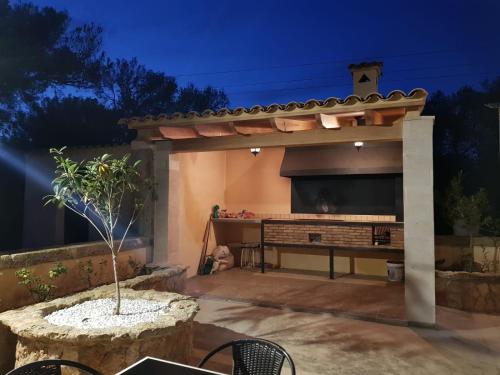 a patio with a large entertainment center with a large television at Villa Dinastía Resort Lujo in Llucmajor