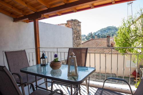 a glass table on a balcony with a view at Central Apartment in Ayios Nikolaos Sithonia