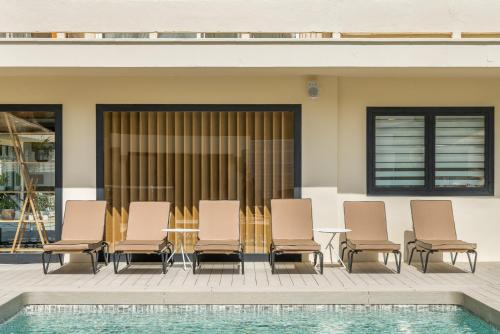 a patio with a table and chairs next to a pool at Hotel Eden Nord Soller in Port de Soller