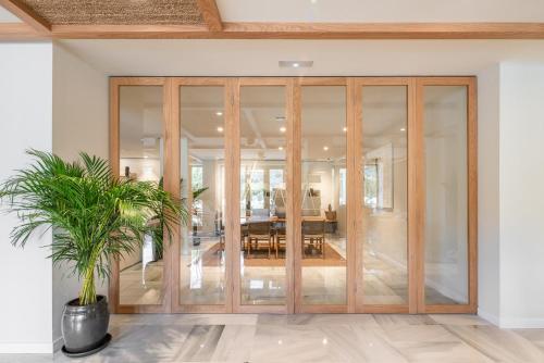 a pivot door in a room with a potted plant at Hotel Eden Nord Soller in Port de Soller