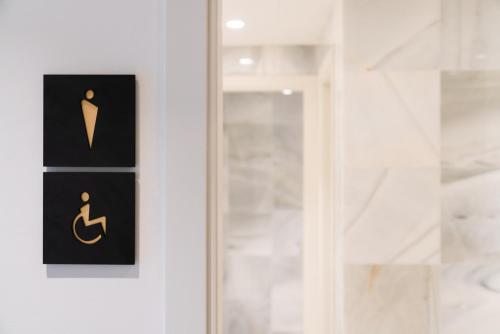 a door with a toilet sign on it at Hotel Eden Nord Soller in Port de Soller