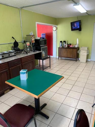 a kitchen with a table in the middle of a room at AmeriVu Inn-Gilbertsville in Gilbertsville