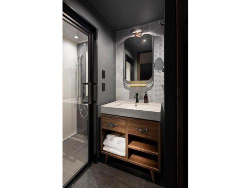 a bathroom with a sink and a mirror at THE LIVELY AZABUJUBAN TOKYO / Vacation STAY 77702 in Tokyo