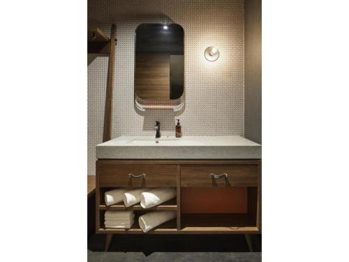 a bathroom with a sink and a mirror at THE LIVELY AZABUJUBAN TOKYO / Vacation STAY 77707 in Tokyo