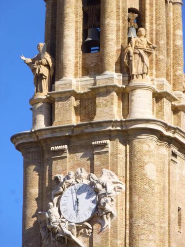 a clock tower with statues on top of it at MODERNO NUEVO Luminoso WI-FI PLAZA DEL PILAR 2 in Zaragoza