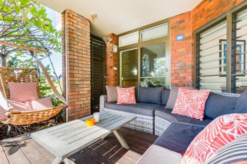 a living room filled with furniture and a fire place at Nautilus Beachfront Villas & Spa in Coffs Harbour