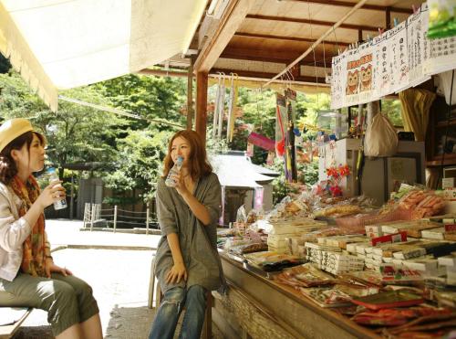 two women sitting in front of a market with drinks at Ryokan Koyokan in Yasugi