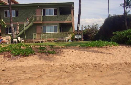 
a house sitting on the side of a beach at Kihei Kai Oceanfront Condos in Kihei

