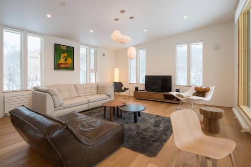 a living room with a couch and a tv at Fuga no Mori by H2 Life Fuga no Mori in Kutchan