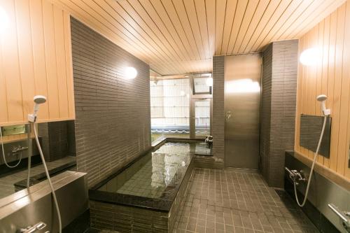 a bathroom with a walk in shower and a pool at Kyonoyado Kagihei in Kyoto
