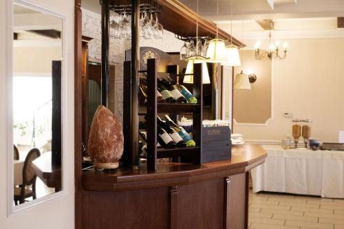 a room with a counter with a bunch of wine bottles at Hotel - Restauracja Koral in Wieliczka