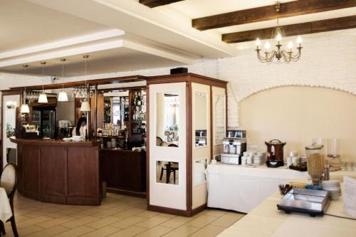a room with a counter and a kitchen with a counter at Hotel - Restauracja Koral in Wieliczka